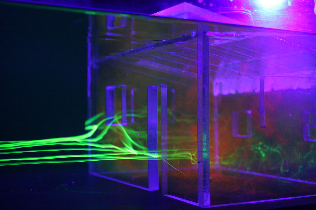Image: Abstract rendering of house frame, aglow in purple light, against a dark backdrop, with neon green beams entering